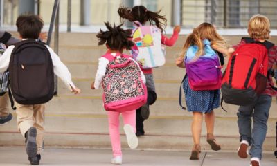 Elementary school kids running into school-School Reopening-ss-featured