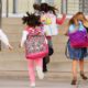 Elementary school kids running into school-School Reopening-ss-featured