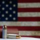 Gun ammunition with US flag in the background-Democrats Use Boulder Tragedy to Push Gun Control Agenda-ss-Featured