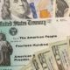 Illustation of dollar bills and a stimulus check-The $1400 Stimulus Checks Could Arrive Starting Next Week Under COVID-19 Relief Package -ss-Featured