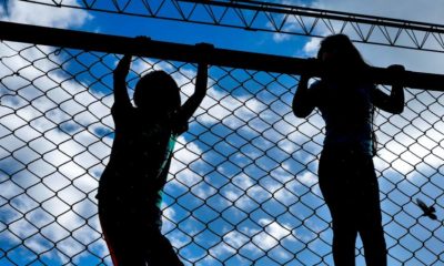 silhouettes of children behind the mesh-kids in cages-SS-featured