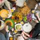 top view of family sharing a meal-CDC Says Fully Vaccinated People can Safely Gather Indoors Without Masks-ss-Featured