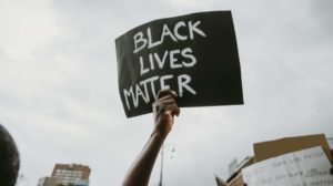 A black lives matter sign-BLM Activist Demands Investigation After Co-Founder Spends Millions on House Shopping Spree -ss-Featured
