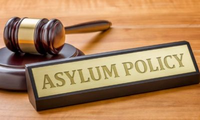 A gavel and a name plate with the engraving Asylum Policy-Asylum System-ss-featured