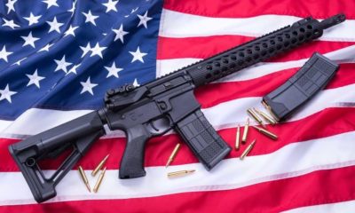 AR-15 and ammo on a US flag-22 States Fight Ridiculous California Gun Restrictions on Large Magazine Ban-ss-Featured