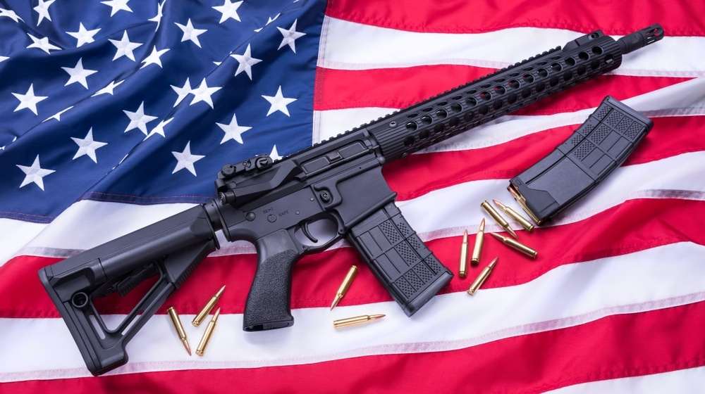AR-15 and ammo on a US flag-22 States Fight Ridiculous California Gun Restrictions on Large Magazine Ban-ss-Featured