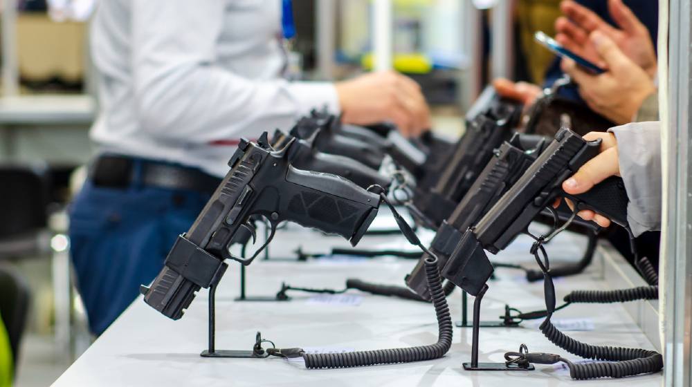 Gun Display Stands. Pistols for sale in the store | Gun Sales Surge As First-Time Owners Snap Up Firearms | Featured