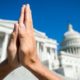 Hands held together in prayer in front on Capitol Building in Washington DC-Christian Minister-ss-featured