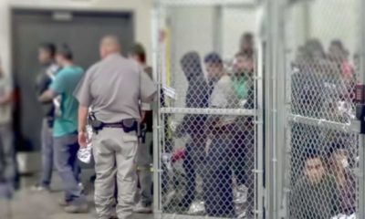 Illegal migrants at a holding facility-As Biden's Border Crisis Continues as Dems Look to Blame Trump -ss-Featured