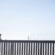 Immigrant on the border wall - New Poll Americans Miss Trump's Border Security Over Biden's Border Crisis -ss-Featured