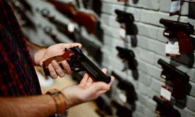 Person looking at a handgun-Thank God For Texas House Passes ' Constitutional Carry ' Bill For Residents to Carry a Gun without a License-ss-Featured