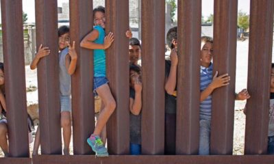 School kids on the US to Mexico border wall in Sunland Park, New Mexico enjoying themselves, Sunland Park-Border Wall Construction-ss-featured
