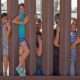 School kids on the US to Mexico border wall in Sunland Park, New Mexico enjoying themselves, Sunland Park-Border Wall Construction-ss-featured