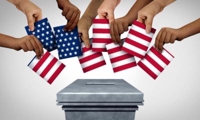 American community vote and US voting diversity concept and diverse hands casting United States ballots | Why Do American Voters Keep Letting Elected Officials Get Away With This? | Featured
