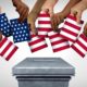 American community vote and US voting diversity concept and diverse hands casting United States ballots | Why Do American Voters Keep Letting Elected Officials Get Away With This? | Featured