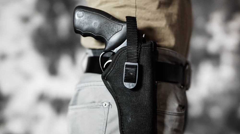 Man openly carrying a revolver in a holster on his belt. Open carry and second amendment concept | Texas Senate Approves Constitutional Carry for Handguns | Featured