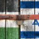 Palestinian flag with the Israeli flag on the background of old locked doors | Israeli Official Vows To Destroy Hamas For Its Rocket Attacks | Featured