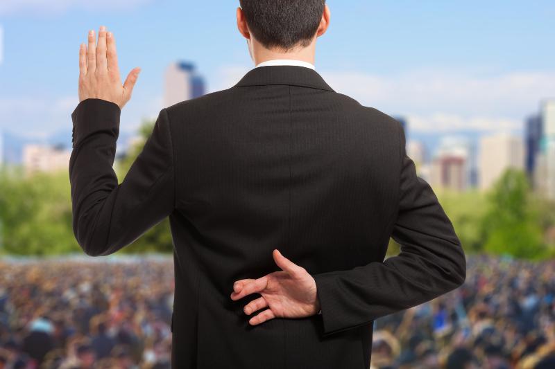 Politician swearing an oath with fingers crossed behind back | 5 Examples When Political Hypocrisy Harms America