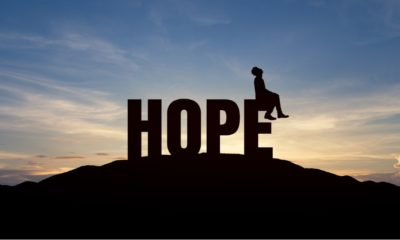 Silhouette of young man and the word hope on mountain over sky and sunset background | 5 Key Areas Where We Must Vote Our Hopes, Instead Of Our Fears! | Featured
