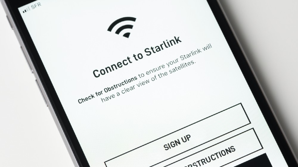 Starlink app on Apple iPhone screen. Starlink is a satellite internet constellation being constructed by SpaceX to provide satellite internet access | Elon Musk’s StarLink Internet Service Gets 500,000 Pre-Orders | Featured