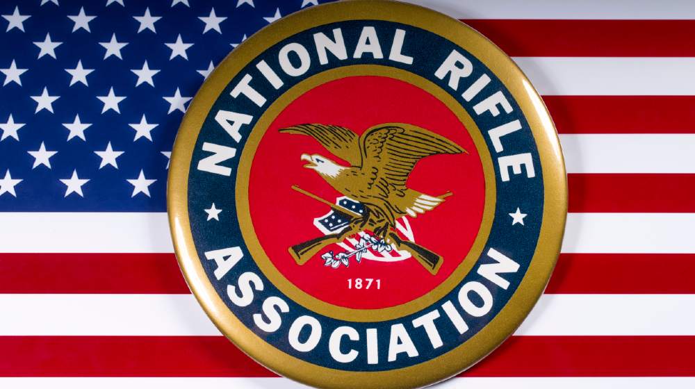 The symbol of the National Rifle Association portrayed with the US flag, on 26th March 2018 | Federal Judge Dismisses NRA Bankruptcy Claim | Featured