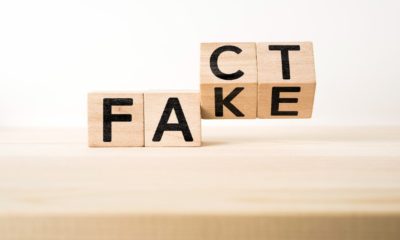 surreal abstract geometric wooden cube take by hand with word FACT & FAKE | How To Differentiate Between Real And Fake Facts? | Featured