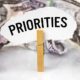 There are dollars on the table and there is a clothespin with paper on which it is written - PRIORITIES | 5 Most Urgent American Priorities | featured
