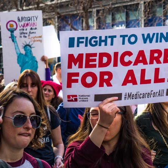 USA - Participant to the Women's March event holds Medicare for all sign while marching on Market street | Schumer Wants Medicare To Cover Dental, Vision, and Hearing | featured