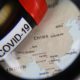 View through magnifying glass on map with focus on China and blood sample vial covid-19 | McCarthy Considers Plans to Sue China For COVID Deaths | featured