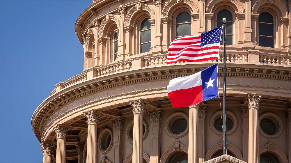 American and Texas state flags flying on the dome of the Texas State Capitol-Texas GOP-SS-Featured