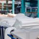 Material on the textile factory. Rolls of industrial cotton fabric for clothing cloth textile manufacture on machine | World's Top 10 Textile Companies | featured