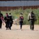 Migrants from Guatemala turn themselves over to a Border Patrol agent after crossing the border wall | Texas Sheriffs Sue Biden Admin Over ICE Restrictions | featured