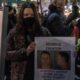 A woman holds a sign with Derrick Chauvin's picture as people gather for a George Floyd protest | Derick Chauvin: The Sacrificial Lamb | featured