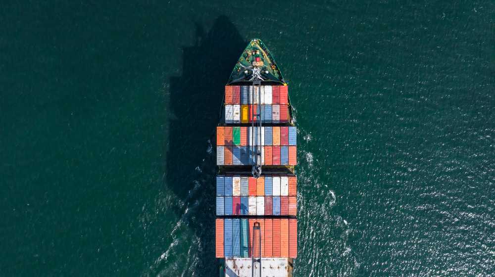 Aerial view container ship carrying container box global business cargo freight shipping commercial | Global Shipping Crisis Will Soon Turn to a Shopping Crisis | featured