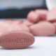 Ivermectin red pill medication on white table medical concept of International nonproprietary name for coronavirus and antiparasitic drug | CDC: Stop Using Ivermectin Instead Of Getting Vaccinated | featured