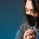 Woman in medical mask praying | Catholic Districts Reject Religious Exemptions For Vaccines | featured