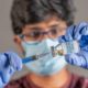 Close up of doctor hands holding covid-19 vaccine booster shot with syringe | FDA OKs Pfizer booster dose for At-Risk Americans | featured