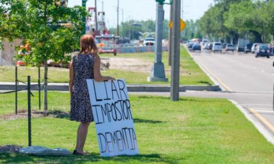 Lone Anti Biden demonstrator with sign on median awaiting presidential motorcade on Claiborne Avenue | Louisiana residents frustrated by FEMA aid | featured