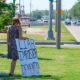 Lone Anti Biden demonstrator with sign on median awaiting presidential motorcade on Claiborne Avenue | Louisiana residents frustrated by FEMA aid | featured