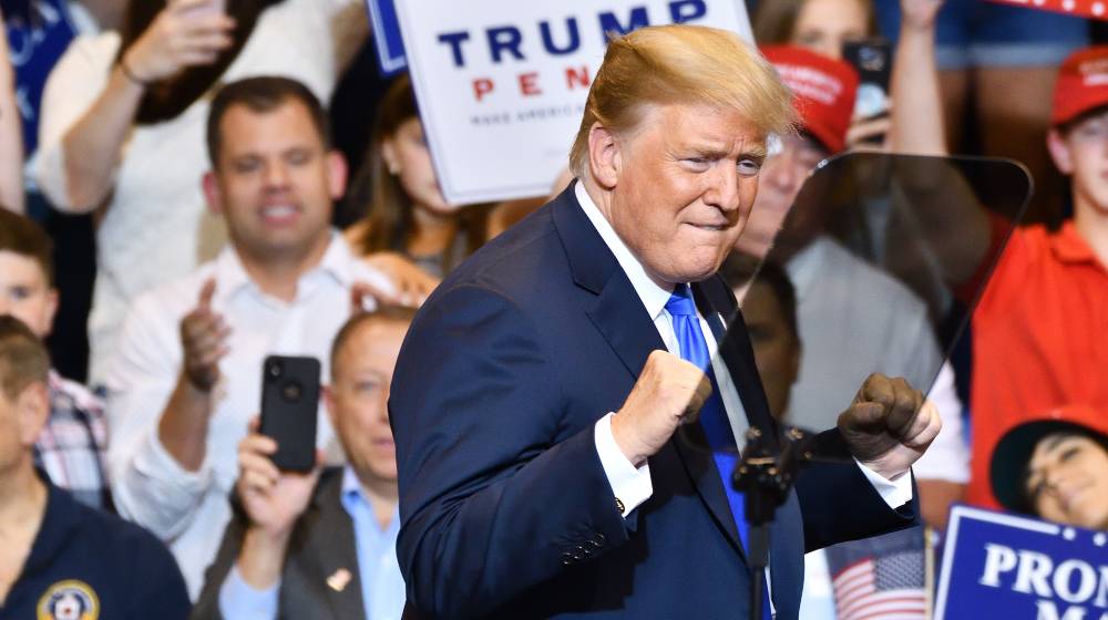President Donald Trump gives a double fist pump gesture during a campaign rally | Trump Beats Biden In Emerson College Poll For 2024 Elections | featured