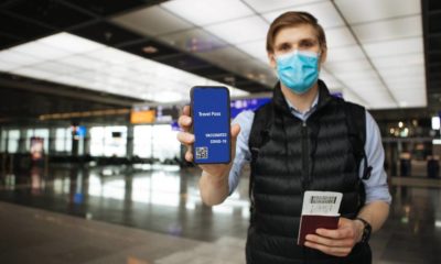 Travel Pass. Hand holding mobile Digital vaccine passport COVID-19 app | IATA Welcomes US Decision to Lift COVID-19 Travel Restrictions | featured