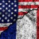two flags of the USA and France on a cracked concrete wall | France Nixes US Gala, Alludes That Biden Is A Backstabber | featured