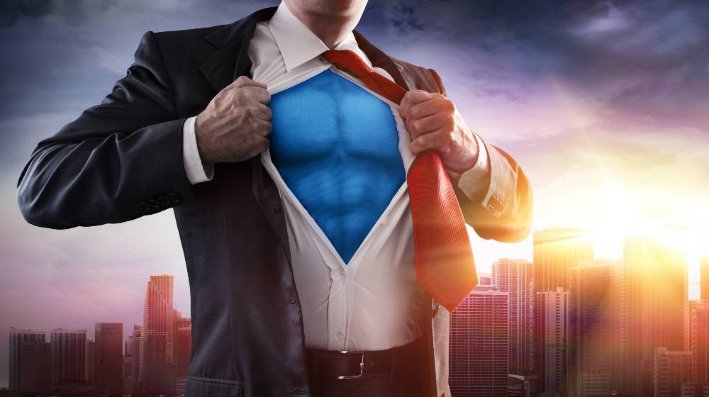 Businessman Superhero With Sunset In City | Jon Kent, the New Superman, Reveals Self As Bisexual | featured