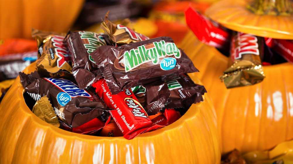 Decorative pumpkins filled with assorted Halloween chocolate candy made by Mars | Do US Troops Enjoy Getting Leftover Halloween Candy? | featured