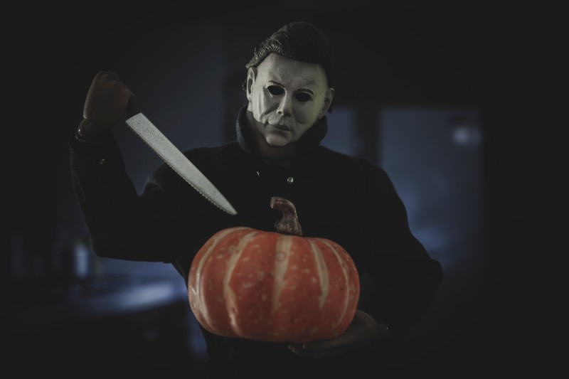 Halloween slasher Michael Myers carving a pumpkin-Michael Myers