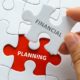 Hand holding piece of jigsaw puzzle with word FINANCIAL PLANNING | Why Financial Planning Is Important for Your Business? | featured