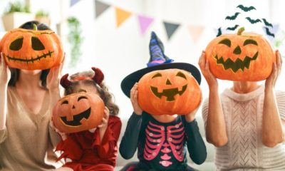Happy family celebrating Halloween. Grandmother, mother and children at home | Fauci Is OK With Kids To Go Trick Or Treating This Year | featured