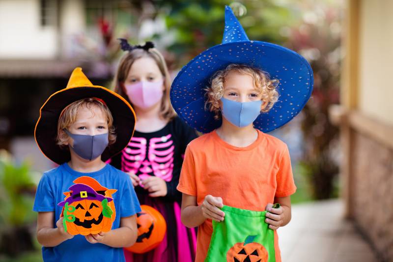 Kids trick or treat in Halloween costume and face mask-Covid Halloween