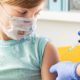 Little girl in face mask in doctor's office is vaccinated. Syringe with vaccine for covid-19 coronavirus | CNN 5 Things