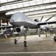 Military Drone UAV aircraft's with ordinance in position in a hangar awaiting a strike mission | US Killer Drone Program Stays Afloat on Sea of Lies | featured